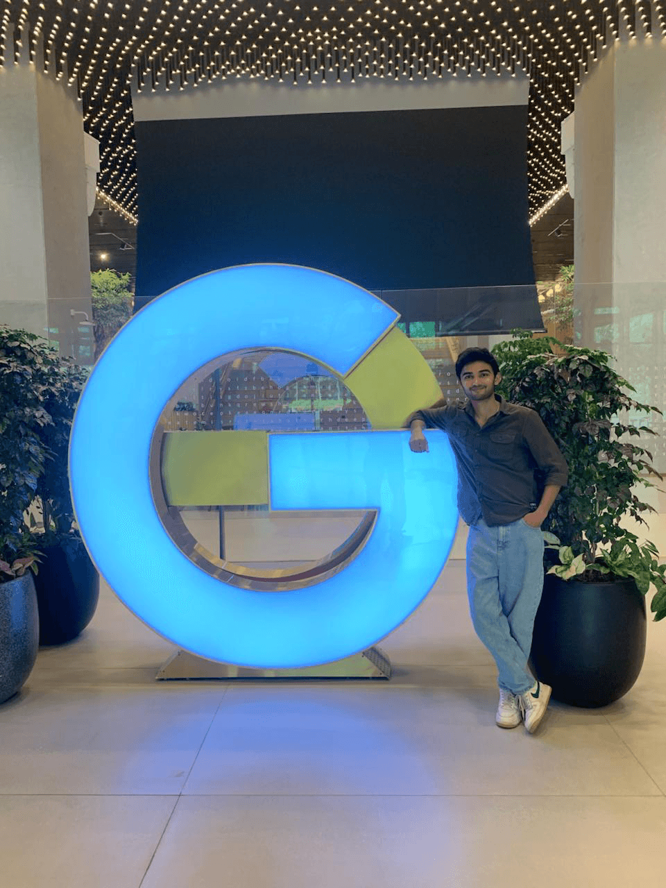 Founder beside a Google sign